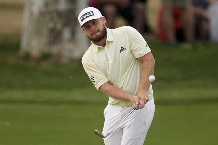 Tyrrell Hatton, of England, chips to the green on the 18th hole