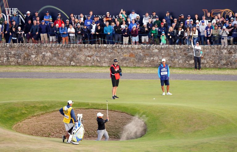 Xander Schauffele blasts out of a bunker
