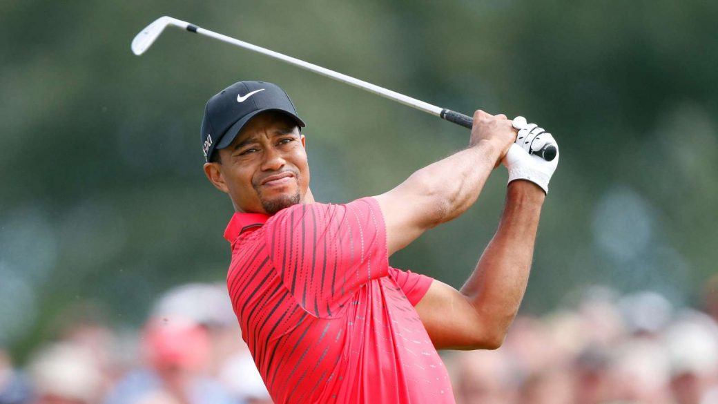 Tiger Woods hits an iron