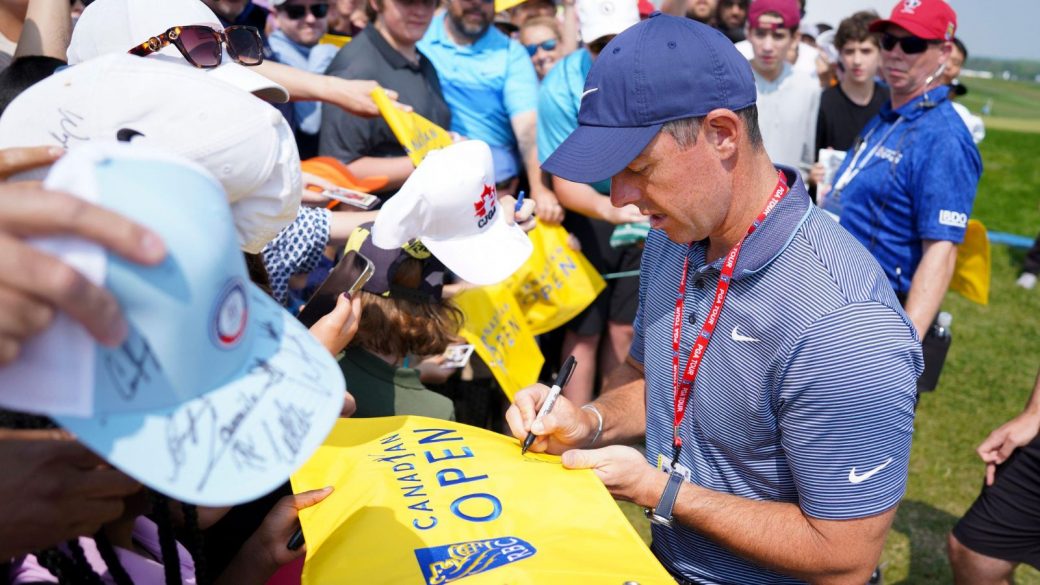 Rory McIlroy signs autographs