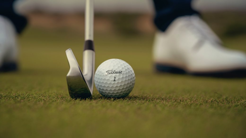 A Titleist ball about to be struck by an iron