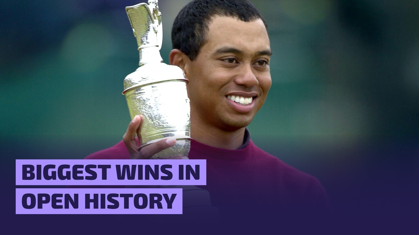 Tiger Woods lifts the 2000 Open trophy aloft