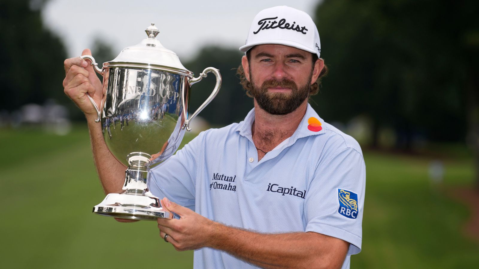 Cameron Young lifts the Wyndham Championship trophy in his first ever PGA Tour win with record prize money.