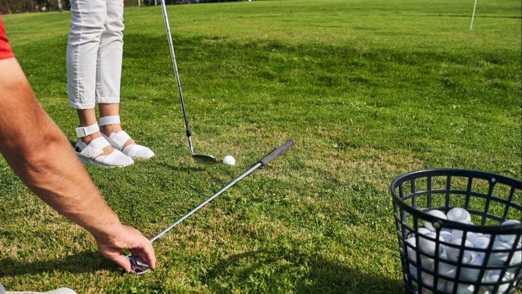Young Caucasian woman taking a golf lesson