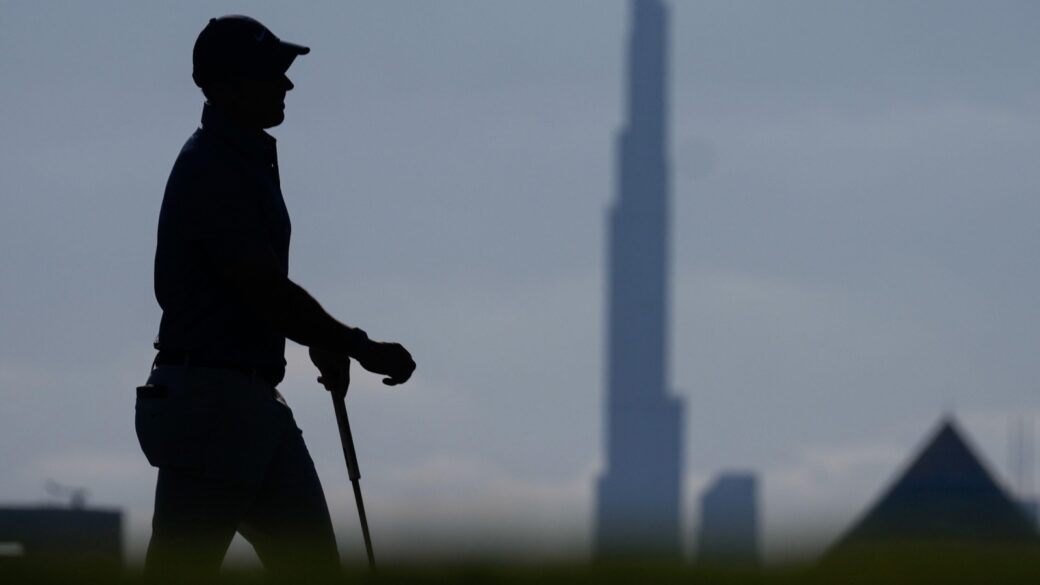 With Burj Khalifa, world's tallest tower, in background, Rory McIlroy of Northern Ireland walks on the 17th green during the final round of Dubai Invitational golf tournament