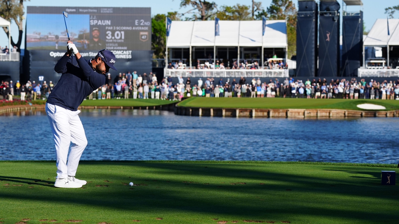 PGA golfer J.J. Spaun hits his tee shot on the 17th hole in the water during the aggregate playoff for The Players Championship