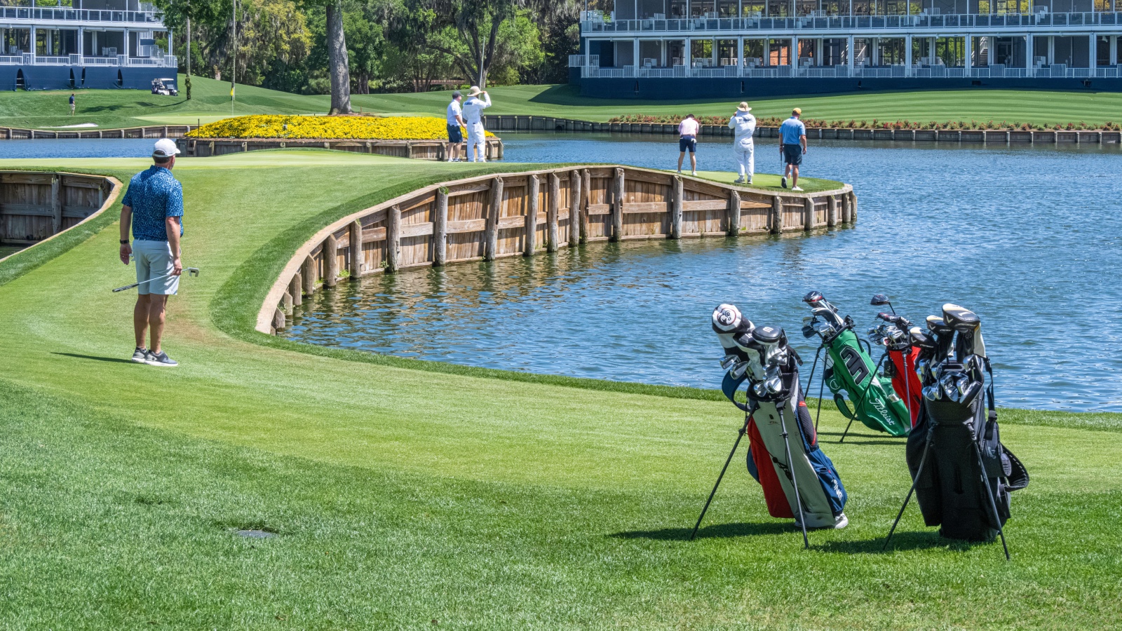 Golfers at the challenging 17th hole of THE PLAYERS Stadium Course at TPC Sawgrass in Ponte Vedra Beach, Florida.