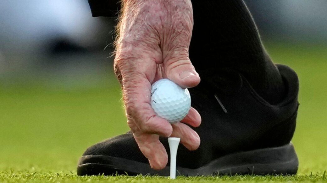 Honorary Starter Jack Nicklaus places his ball on the tee on the first hole during the first round at the Masters golf tournament
