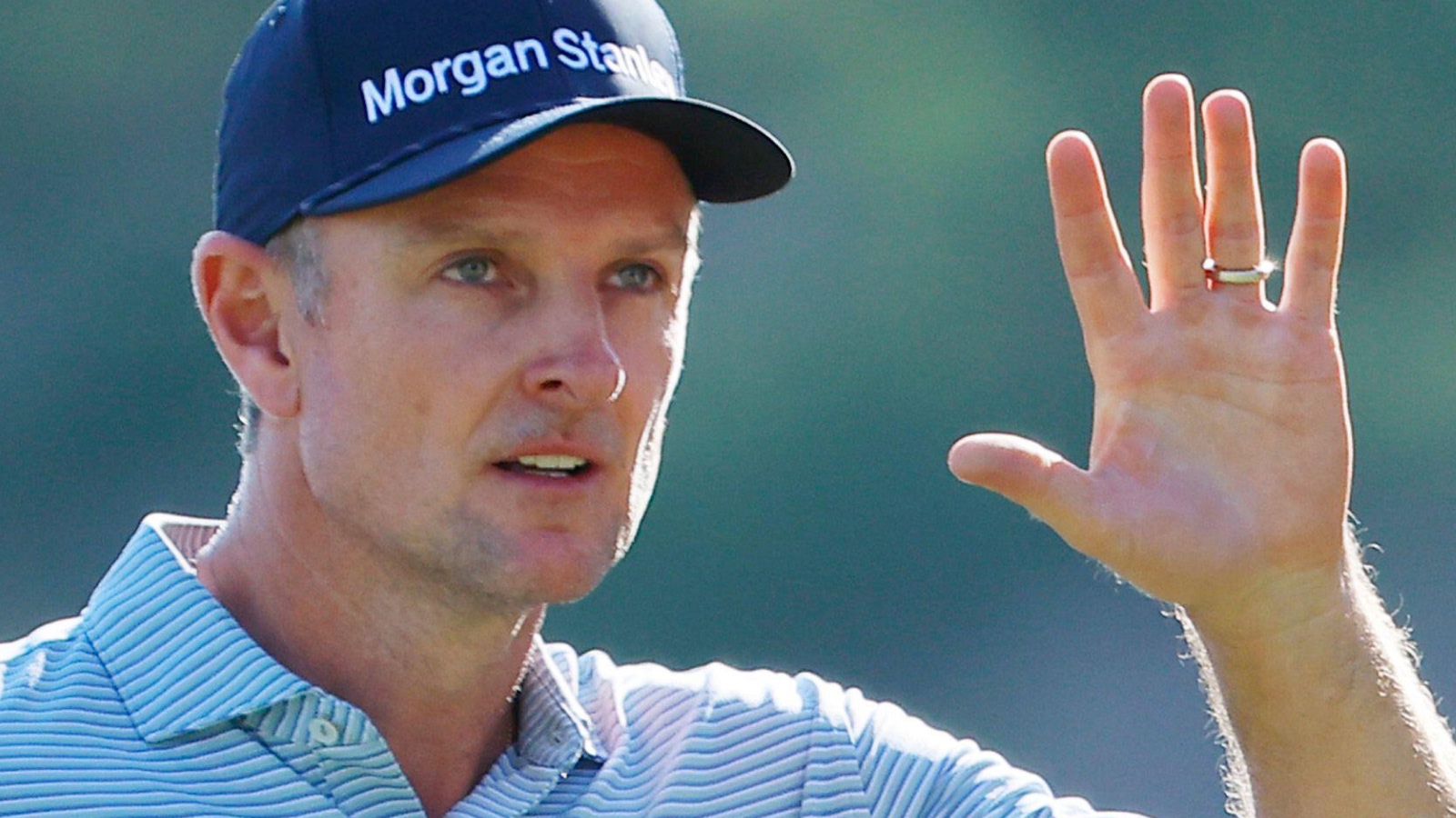Justin Rose waves to the crowd