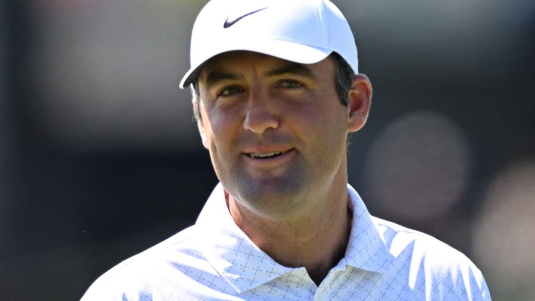 Scottie Scheffler smiles on the green at Newton Square